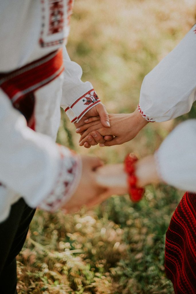 a-group-of-people-holding-a-red-and-white-can-0nosurl7h2g