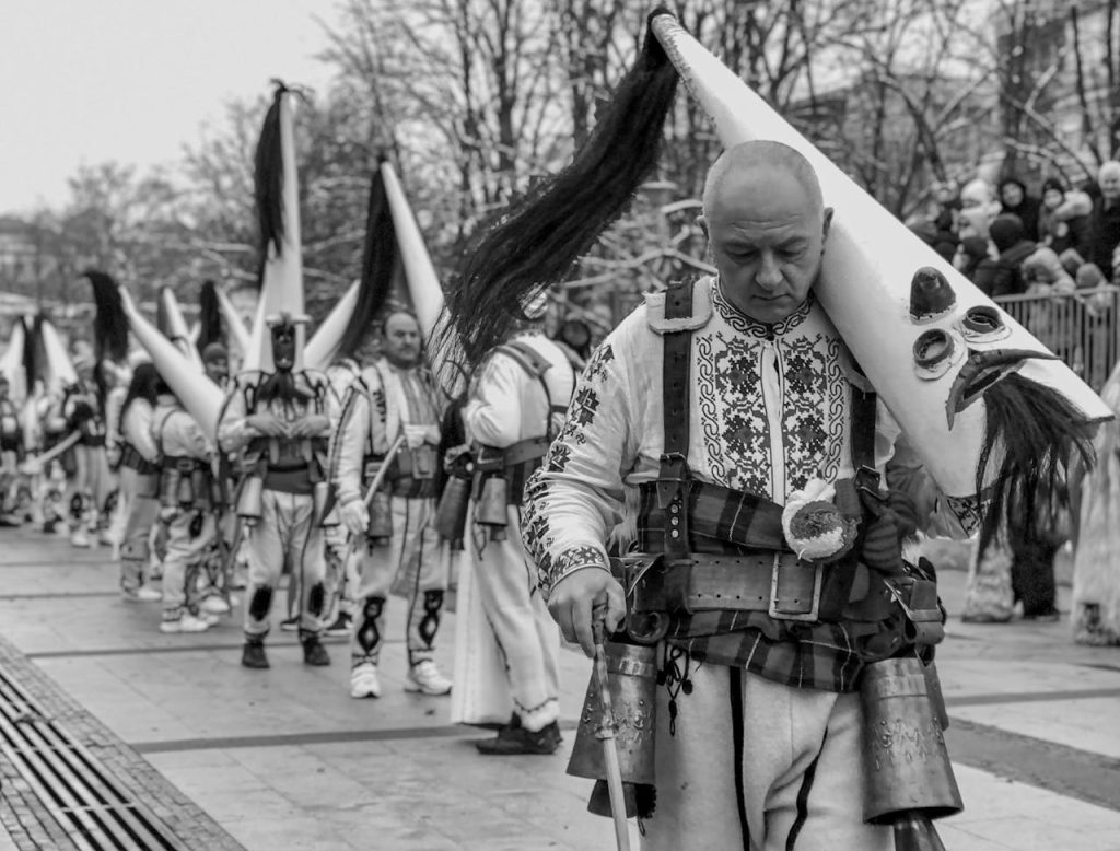 Men in traditional costumes at the Bulgarian Kukeri Festival in Pernik, showcasing cultural heritage.