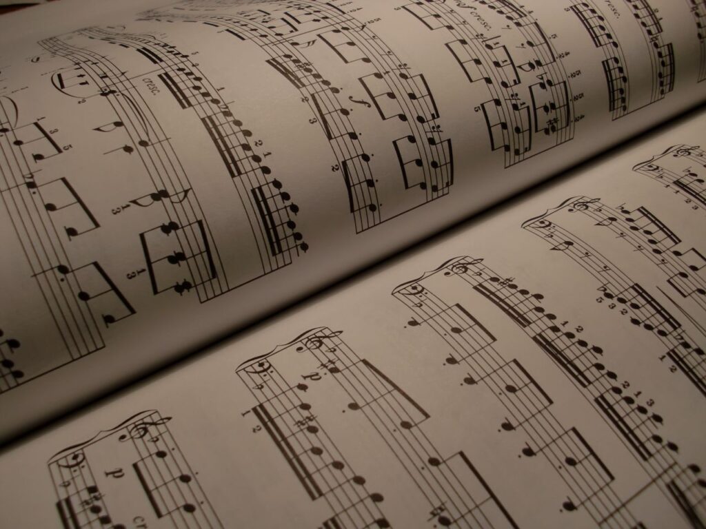 pexels photo 210804 210804 Detailed view of an open music book displaying musical notes and sheet music.